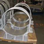 Custom clamp saddles with stainless steel slide plates